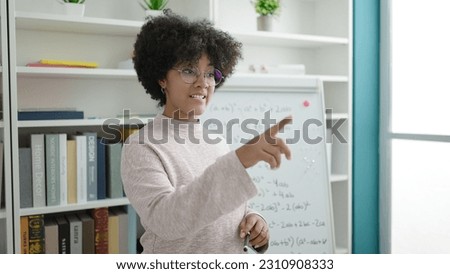 Young african american woman teacher teaching maths lesson at university classroom