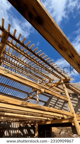 Wooden Roof Structure with blue sky. Wooden structure. Building reconstruction. stock photo