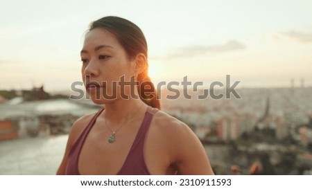 Close-up, girl meditating while sitting on viewing platform at dawn