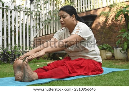 An Indian woman doing yoga in the park
