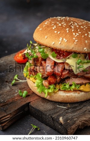 delicious homemade burgers of beef, cheese and vegetables on a wooden board, Hamburger. Fast food concept.
