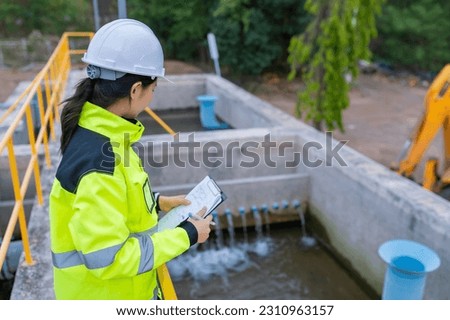 Environmental engineers work at wastewater treatment plants,Water supply engineering working at Water recycling plant for reuse,Check the amount of chlorine in the water to be within the criteria. Royalty-Free Stock Photo #2310963157