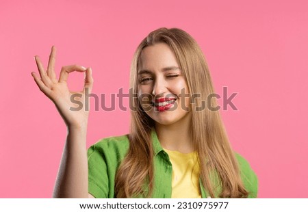 Pretty woman makes hand sign okay, ok gesture. Happy girl, correct perfect choice, great deal, pink background. Positive female model smiles to camera, approval, trust concept. quality