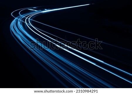 blue car lights at night. long exposure Royalty-Free Stock Photo #2310984291