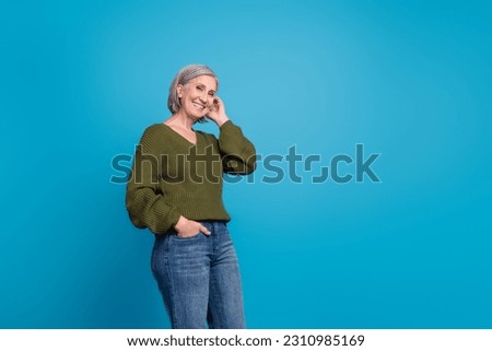 Photo of cute grandmother woman grey hair touch her hair wear stylish casual outfit preppy shopping ad isolated on blue color background