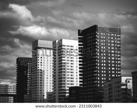 Low angle view of the buildings against sky in black and white 