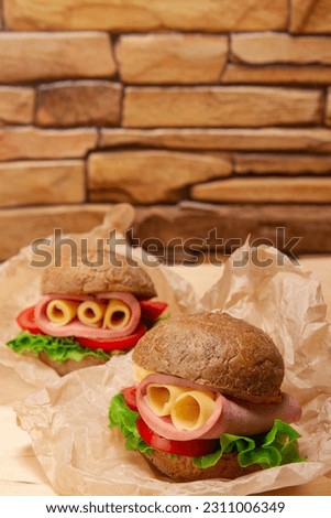 Turkey Sandwich With Tomato And Lettuce on brown brick wall background with copy space