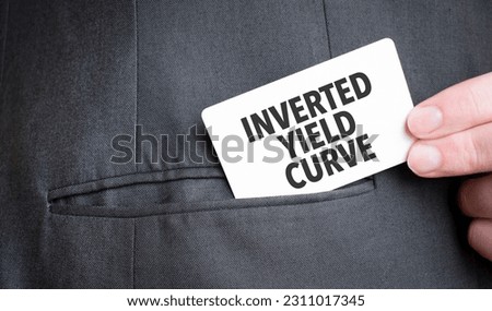 Card with INVERTED YIELD CURVE text in pocket of businessman suit. Investment and decisions business concept.