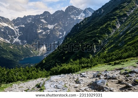 Mountain landscape with a view of the panorama of the peaks of the Tatra National Park, mountains valley with Morskie Oko In the foreground: a footpath