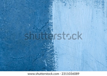 White paint brush stroke spots two color on old concrete blue surface cement wall abstract design pattern texture background. Royalty-Free Stock Photo #2311036089