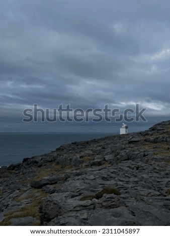 A calm photo taken in Ireland with a blackhead lighthouse in the background. 