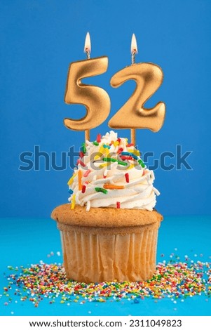 Birthday cake with candle number 52 - Blue background