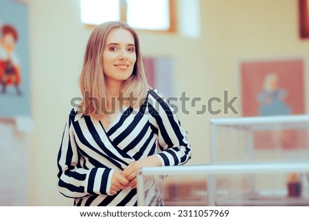 
Woman Attending a Cultural Event Visiting Art Show. Art gallery curator welcoming visitors in a showroom 
 Royalty-Free Stock Photo #2311057969