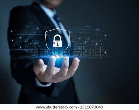 Businessman holding a protection sign. Represents protection against external hacks. Concepts of protection against code, viruses, firmware and malware.
