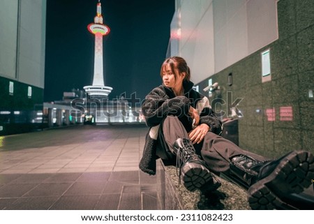 Beautiful woman posing coolly at kyoto station. Royalty-Free Stock Photo #2311082423