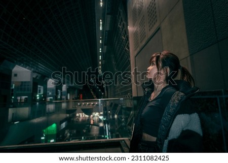 Beautiful woman posing coolly at kyoto station. Royalty-Free Stock Photo #2311082425