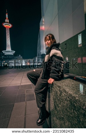 Beautiful woman posing coolly at kyoto station. Royalty-Free Stock Photo #2311082435