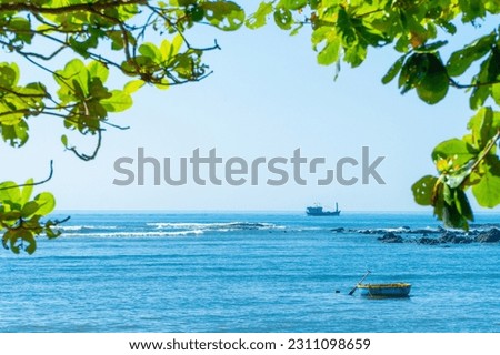 The green branches of a big tree reach out to the sea, behind is the blue sea with waves and boats. Green tree and sea nature icon background.