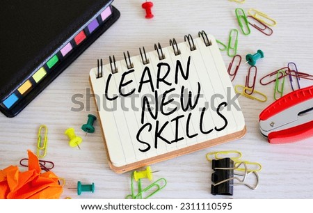 Learn new skills symbol. Concept words Learn new skills on white notebook. Beautiful wooden background. Business and Learn new skills concept. Copy space.