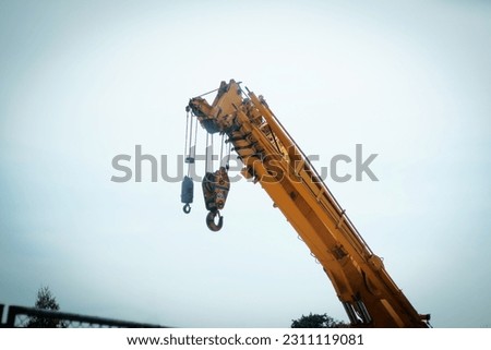 the hook block of the mobile crane and slinging that inspector inspected before starting work, the main construction built is heavy equipment. Royalty-Free Stock Photo #2311119081