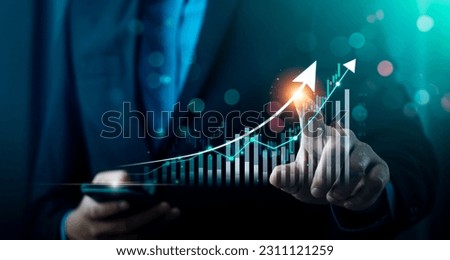 Businessman using laptop and analyzing economic growth, financial graph and business investment. planning strategy, stock market statistics, stock market trends, technical analysis strategy, value Royalty-Free Stock Photo #2311121259