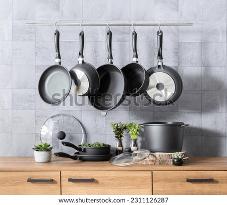 An organized kitchen countertop featuring a variety of essential cookware and utensils Royalty-Free Stock Photo #2311126287