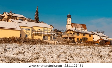 Winter landscape on a sunny day with a church at Welchenberg, Bavaria, Germany