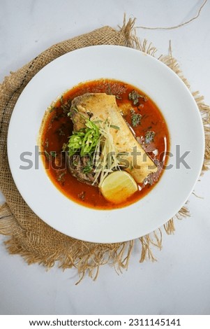 Nihari is a rich, slow-cooked meat stew flavored with spices and thickened with flour, or Pakistani  Indian-style durum whole wheat flour. Pakistani versions of Nihari are typically made with beef. Royalty-Free Stock Photo #2311145141