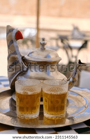 Serving Traditional Mint Tea with Teapot and Glasses