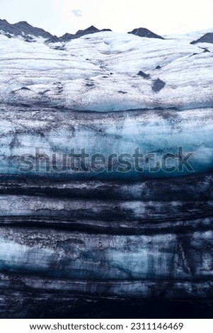 Geological Tapestry: Katla's Ashes Layered in Mýrdalsjökull Glacier