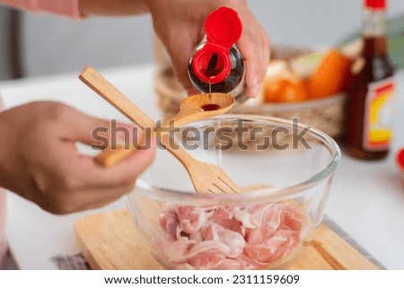 Step-by-step procedures to marinate pork for easy Korean cooking, add chopped onions and Japanese bunching onion, sesame oil, soy sauce, Korean gochujang and mix well. Korean homemade food for lunch Royalty-Free Stock Photo #2311159609