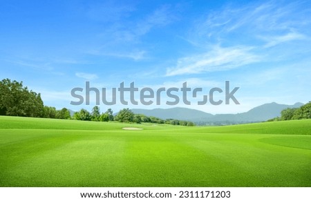 Golf course with mountain and blue sky background. Royalty-Free Stock Photo #2311171203