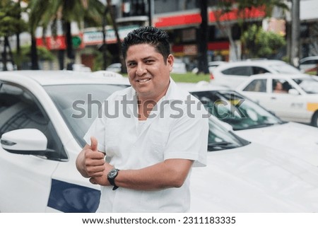 portrait of latin taxi driver man with car on background at city street in Mexico in Latin America, Hispanic people Royalty-Free Stock Photo #2311183335