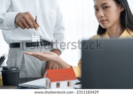 Real estate agent holding house model and keys, customer signing contract to buy house, insurance or loan real estate.