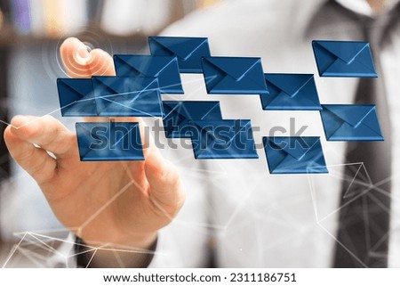 A businessman pointing to a 3D rendered hologram of blue envelope icons in cyberspace