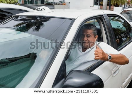 portrait of latin taxi driver senior man with car on background at city street in Mexico in Latin America, Hispanic adult people Royalty-Free Stock Photo #2311187581