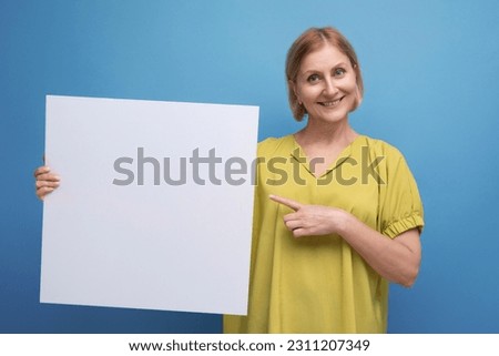 middle aged woman holding poster mockup for information