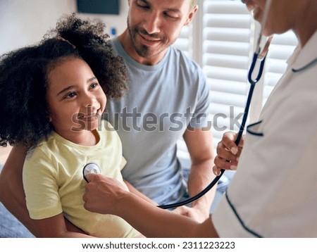 Nurse Wearing Uniform Listening To Girl Patient's Chest With Stethoscope In Private Hospital Room Royalty-Free Stock Photo #2311223223
