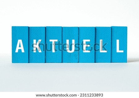 Aktuell - word concept on building blocks, text, letters