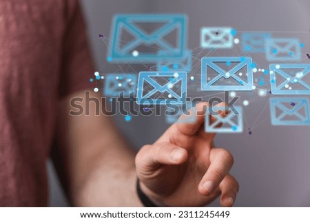 A person pointing to 3D rendered blue email envelope icons