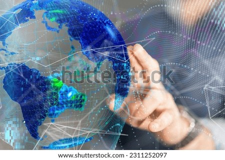 A hand pointing at a hovering digital hologram of the globe. Royalty-Free Stock Photo #2311252097
