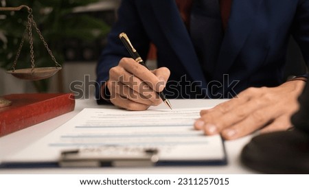Male lawyer working with law book, A legal binding, Unilateral contract, Multilateral, Non-reciprocal contract, Default, Obligation, Power of attorney, Defense of a prescription, Court decree Royalty-Free Stock Photo #2311257015