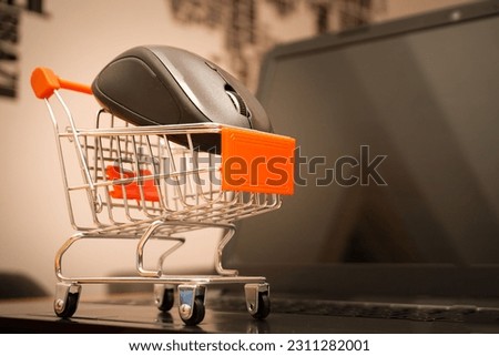 A miniature shopping cart on a laptop - online shopping concept