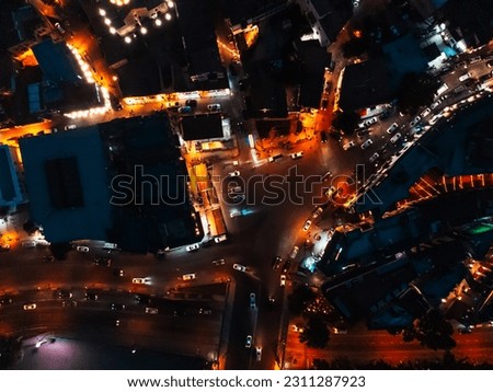 Night city. Aerial photography of Tbilisi at night. View of the old city, Mtatsminda Park, Funicular, TV Tower, Rustaveli Avenue and Liberty Square, Kura River and Trinity Church. Street lights.