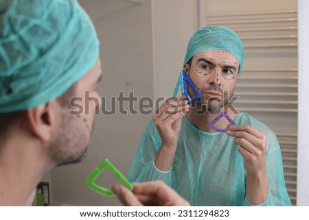 Plastic surgery patient checking his face symmetry  Royalty-Free Stock Photo #2311294823