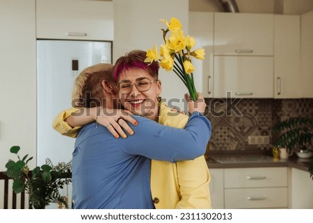 Embracing Generations: daughter and mother hugging and rejoicing on birthday