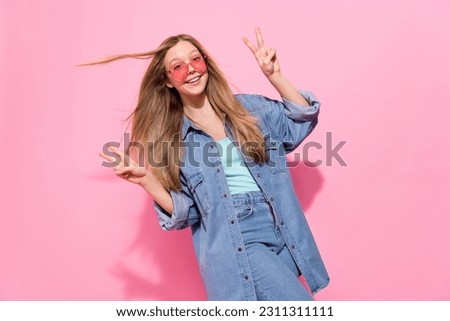 Photo portrait of attractive young teenager woman showing double v-sign wear trendy jeans clothes isolated on pink color background