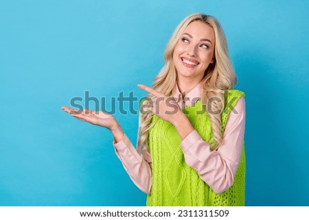 Photo of elegant stylish girl promoter hold open palm arm sale proposition wear smart casual outfit isolated blue color background