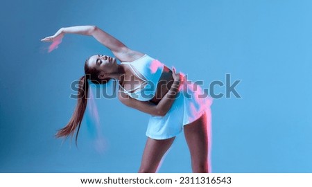 A beautiful athletic woman tilts her body to the left. Portrait of a girl in a white sports uniform on a blue background. The concept of a healthy lifestyle.