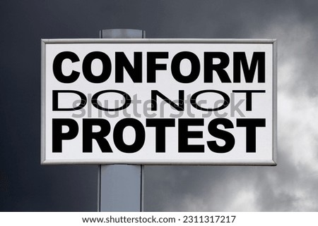 Close-up on a white billboard against a cloudy sky with the message "Conform, do not protest" written in the middle.